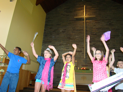 Children dancing and waving their arms