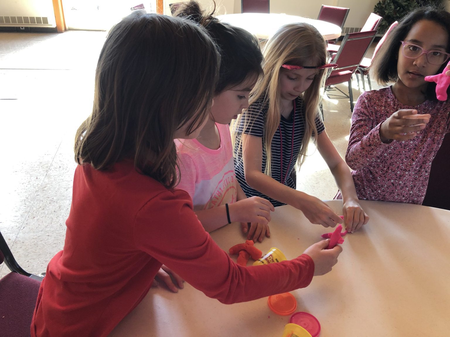 Four girls playing with Playdough