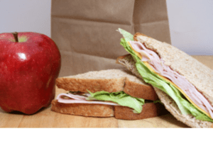 bag lunch of apple and turkey sandwich