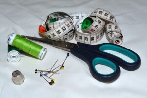 sewing items of scissors, thread, measuring tape.