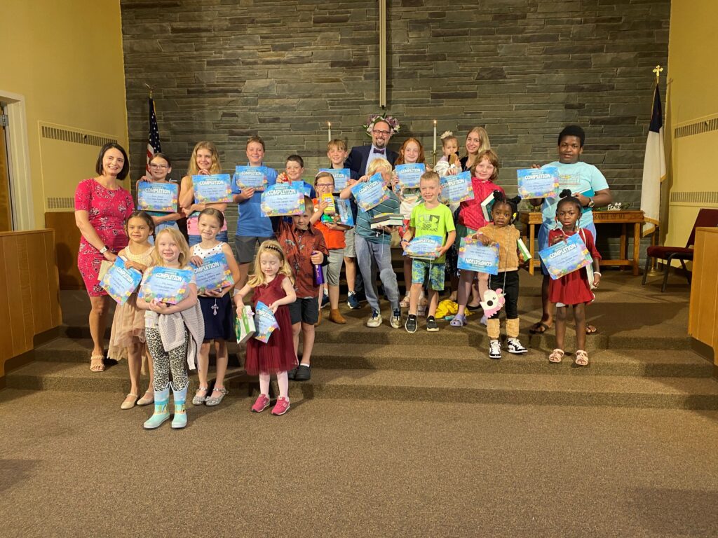 Sunday School children holding certificates