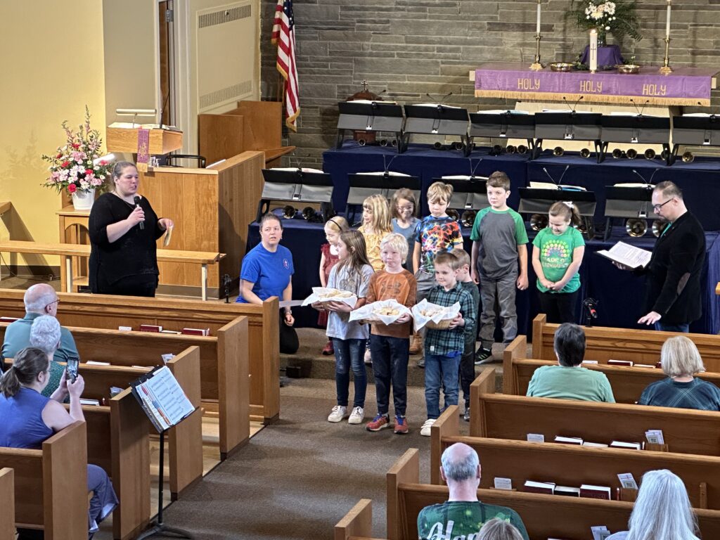 Sunday School children holding baskets of pretzels