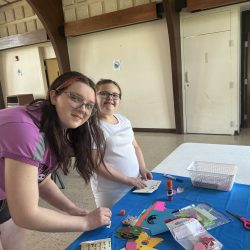 Two girls making paper cards