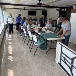 Women at tables cutting paper