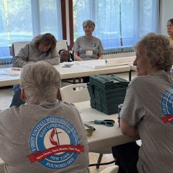 Women at tables cutting paper
