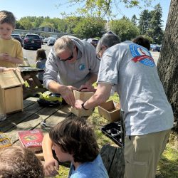 Youth making birdhouses with adult help